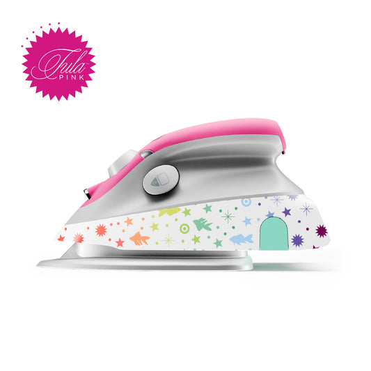 A beautfil colourful mini craft iron by the designer TulaPink, it's pink and white with rainbow stars on goldfishes on